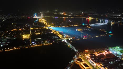 Aerial Night View of a Chinese City with Illuminated Buildings and River