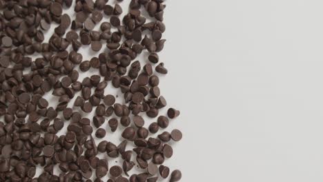 video of close up of multiple chocolate chip with copy space over white background