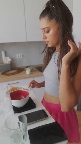 young woman preparing matcha tea in the kitchen