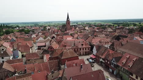 a stationary 360 panning footage to the right while revealing the grassland, some crops and the whole village