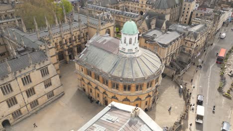 drone flying around the sheldonian theatre, bright sunlight shines on the building