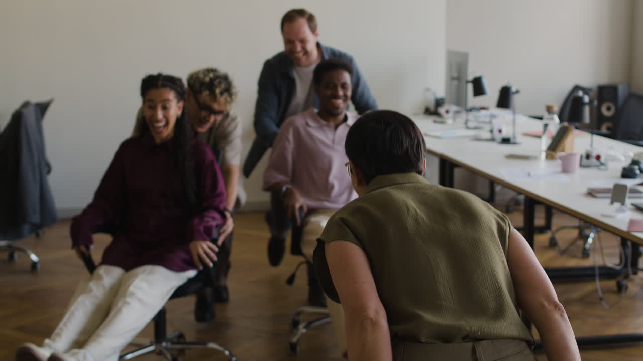 Colleagues Having Fun with Office Chair Races
