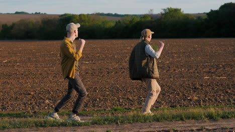 two young men walking in a field