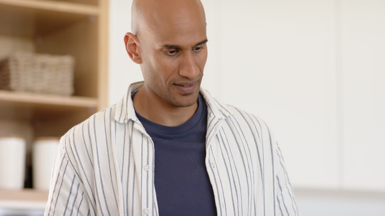 After grabbing pan and spatula, man stirring ingredients, inspecting and nodding in home kitchen