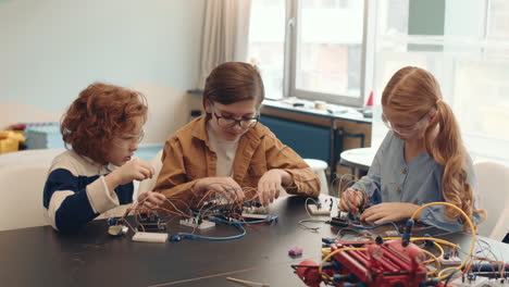children learning robotics and electronics in a stem workshop