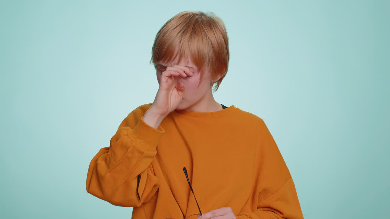 Exhausted tired woman takes off glasses feels eyes pain being overwork burnout working headache