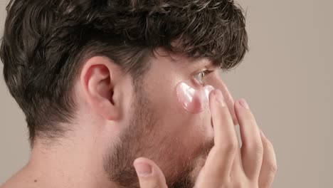man applying facial and eye masks