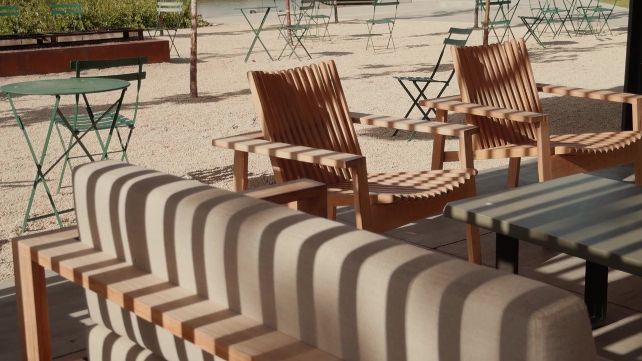 A slow gliding shot moves left to right, revealing outdoor lounge chairs and patio seating.