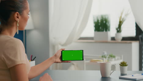 Business-woman-holding-phone-with-mock-up-green-screen-chroma