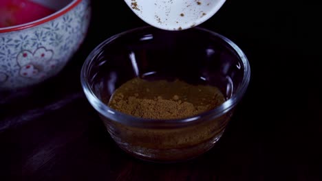 mixing curry and masala in water to make a curry paste to add to a papaya curry dish