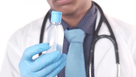 doctor holding hand sanitizer bottle