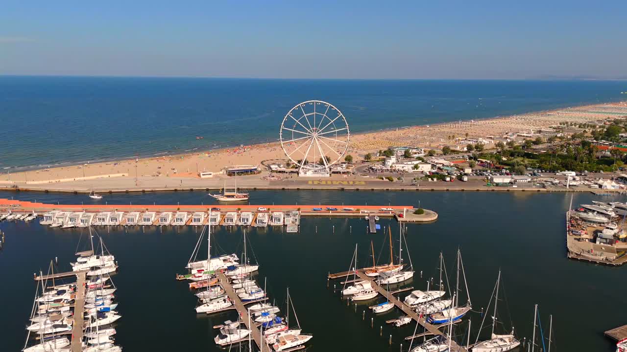 The aerial views of Rimini capture the lively beach atmosphere, with vibrant umbrellas and sunbathers enjoying the sun, creating a perfect summer escape.