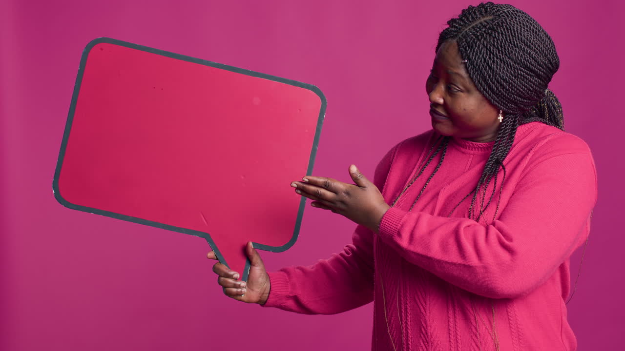 Woman Holds Speech Bubble In Right-Hand