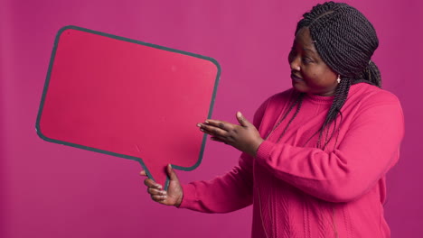 Woman-Holds-Speech-Bubble-In-Right-Hand