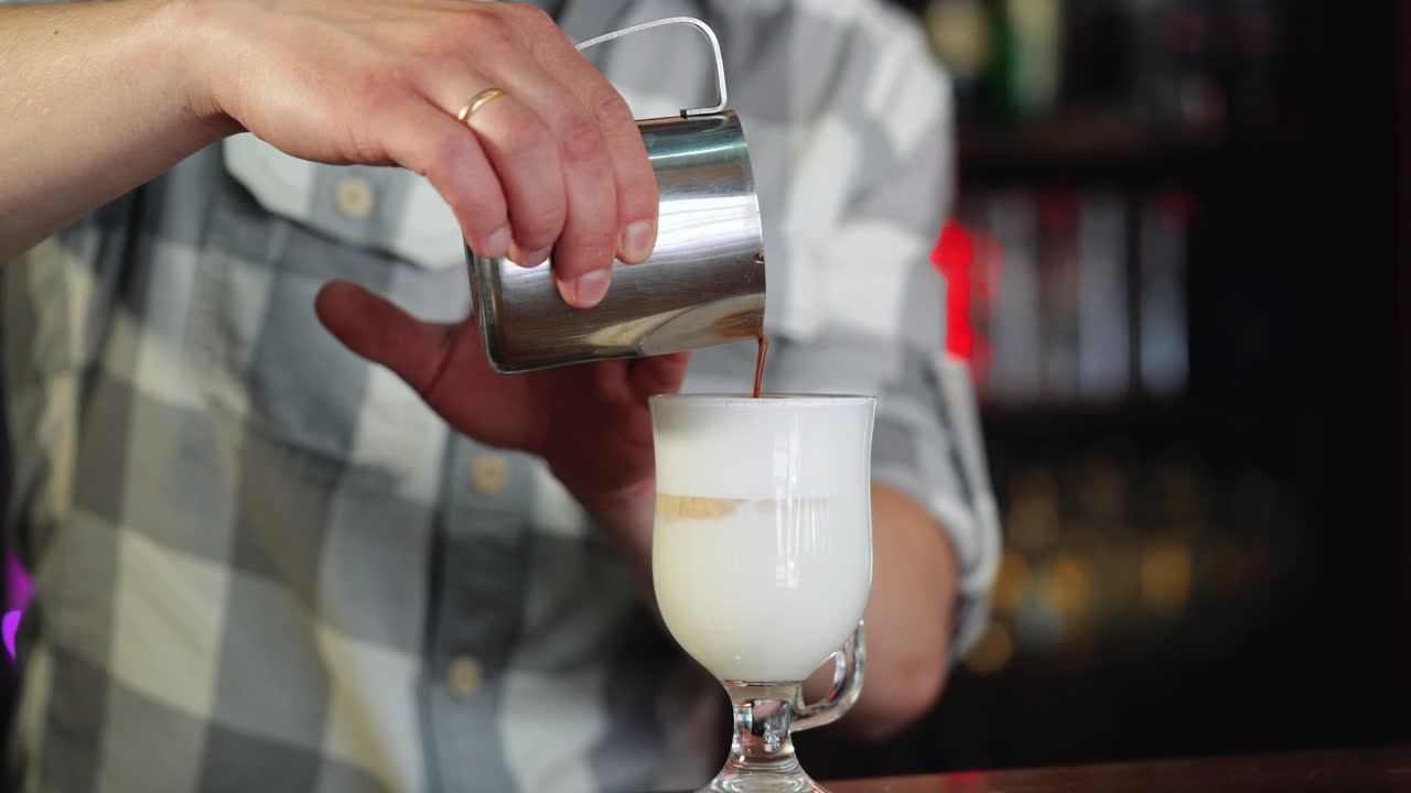 Barista prepares coffee with milk. Latte cup at the Coffee House. Coffee with milk.