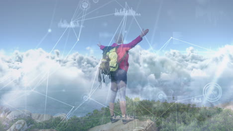 caucasian senior man hiking in countryside on hill with arms raised, over network of connections