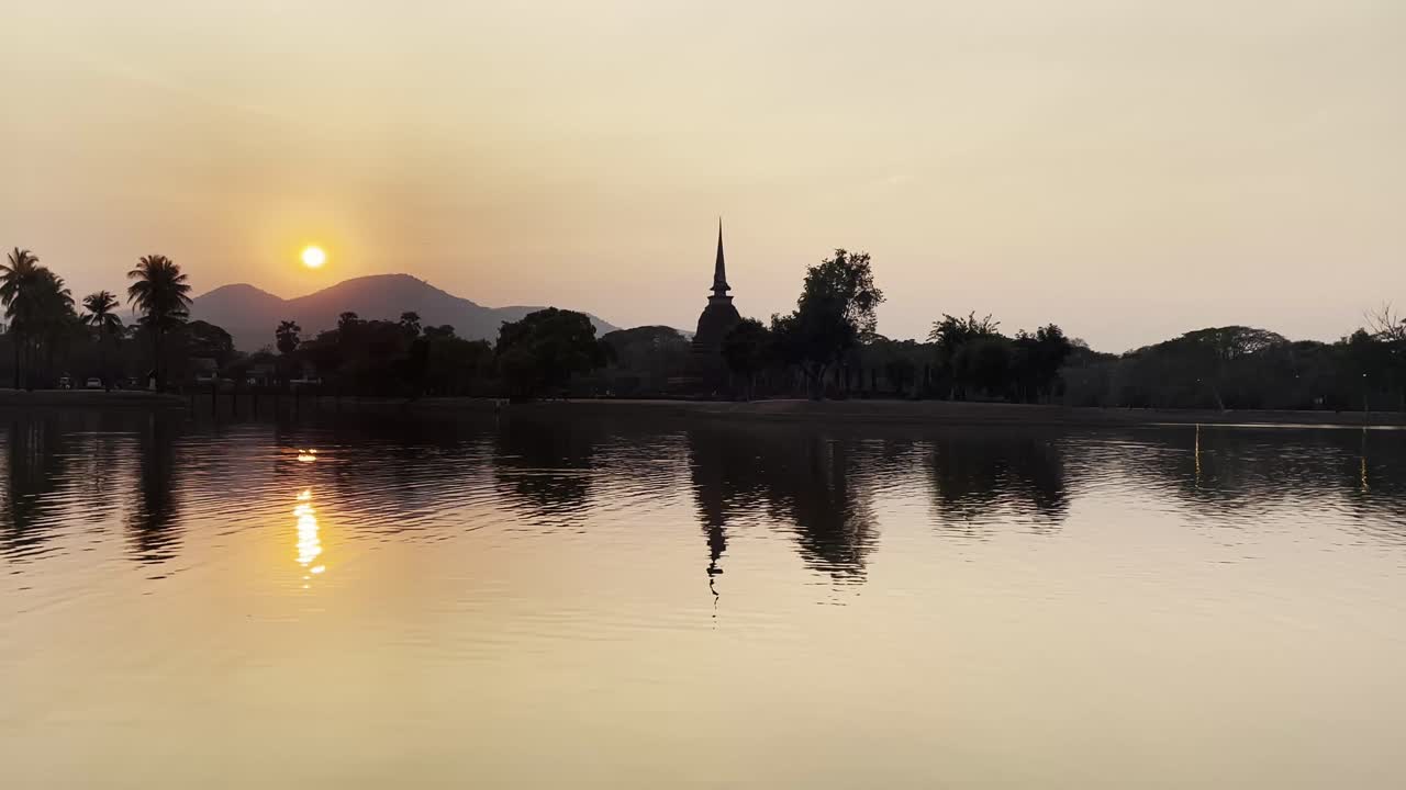 sunset silhouette of Sukhothai Thailand Historical Park, ancient ruins pagoda and temple buddhist cultural unesco heritage