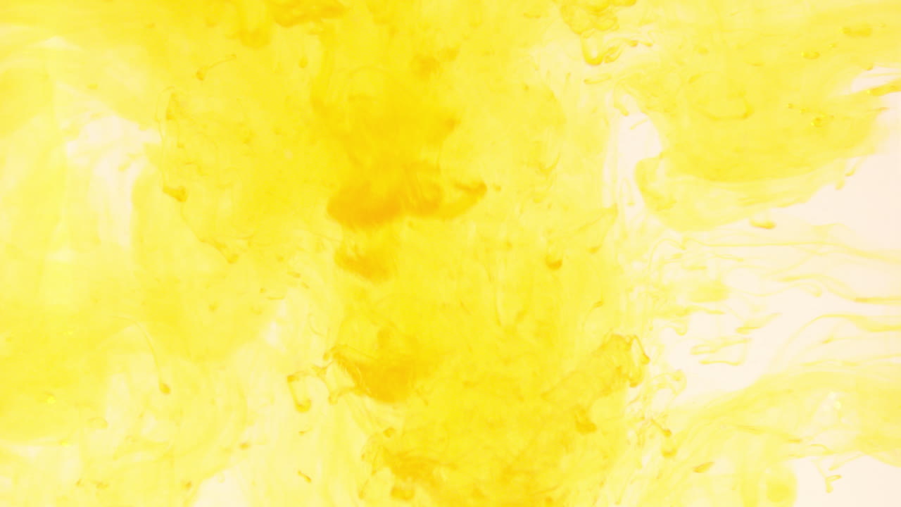 Yellow food coloring dropping in water