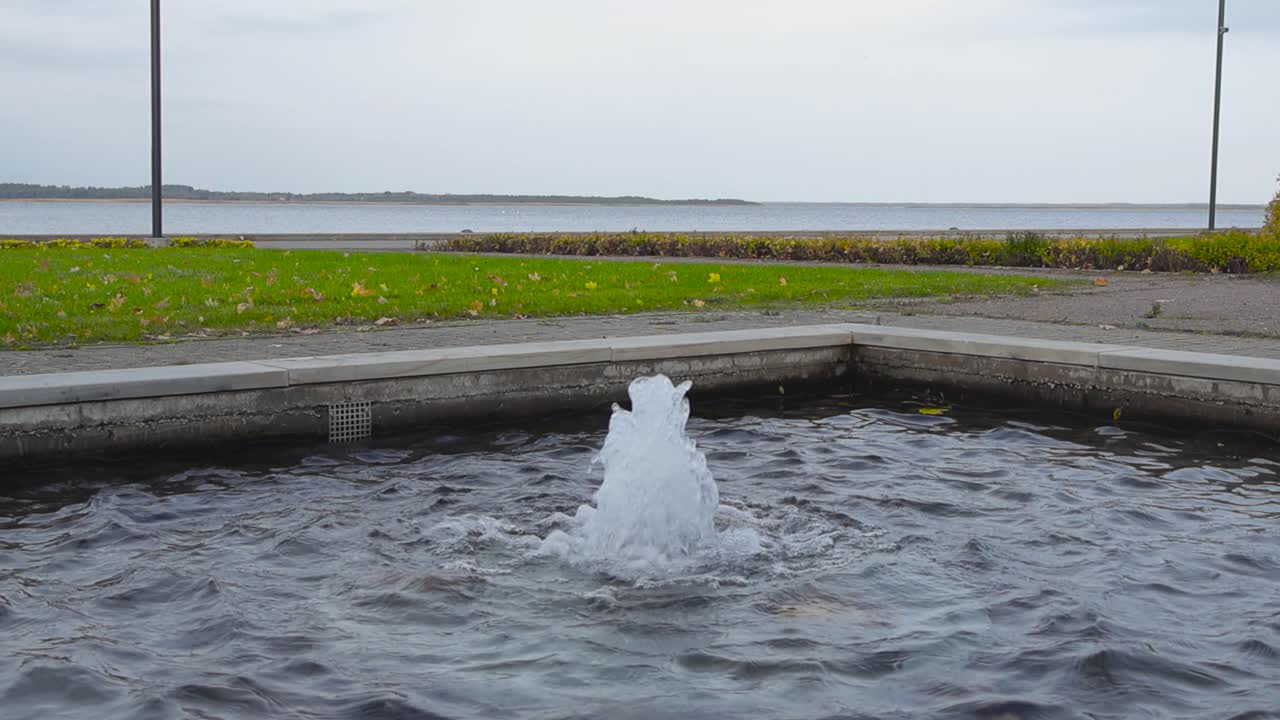 Small fountain in a park by the sea