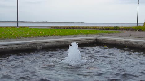 small fountain in a park by the sea