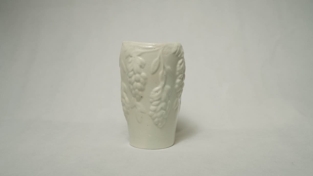 Completed bespoke clay vase handmade with grape outline