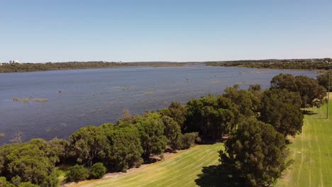 crane shot of lake joondalup, the trees and fields of rotary park wanneroo