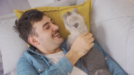 man sleeping with cute scottish fold kittens is happy.