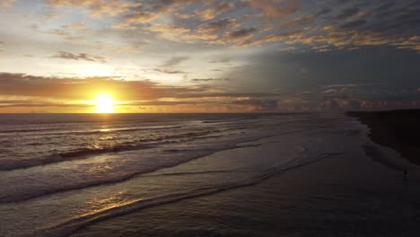 drone flying forward along breathtaking tropical sunset beach