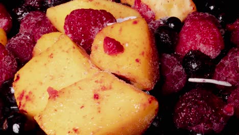 slow dolly slider showing defrosting tropical fruits,illuminated in studio