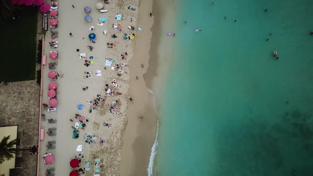 Crowded Beach Coastline with Tourists on Vacation in Waikiki, Hawaii, Aerial Drone
