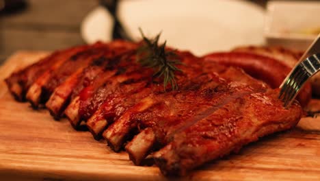 carving succulent ribs on a wooden board