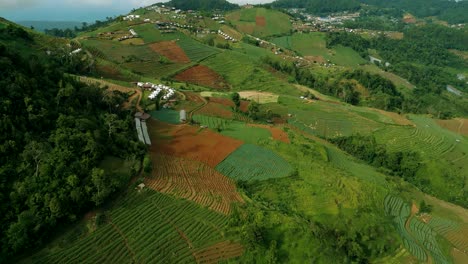 4k cinematic nature aerial footage of a drone flying over the beautiful mountains of mon jam next to chiang mai, thailand on a sunny day