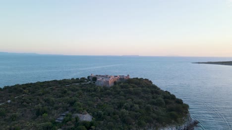 Aerial-view-of-Porto-Palermo-Castle-on-island-with-beautiful-Mediterranean-waters-in-Himara,-Albania