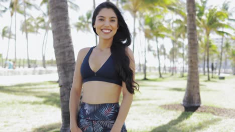 laughing sportswoman looking at camera outside