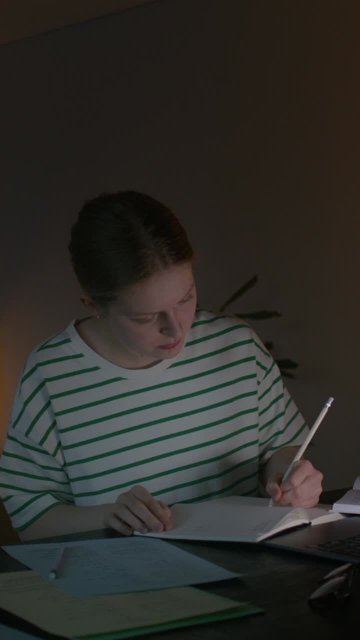Young woman studying late into the night