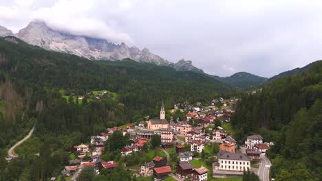 snow-capped peaks tower over the quaint town, creating a breathtaking contrast of nature and civilization.