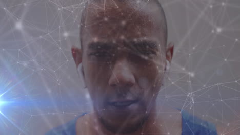 animation of light trails and network of connections over african american man