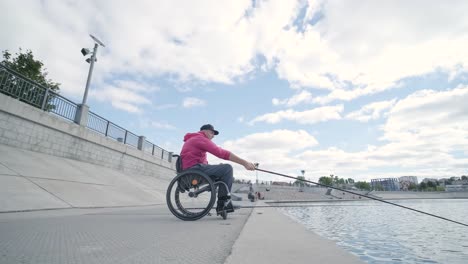 person with a physical disability who uses wheelchair fishing from fishing pier