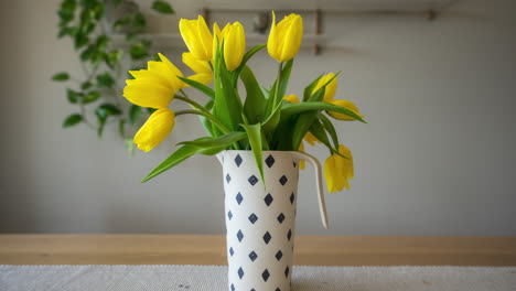 beautiful yellow tulips rising in flower vase on the table