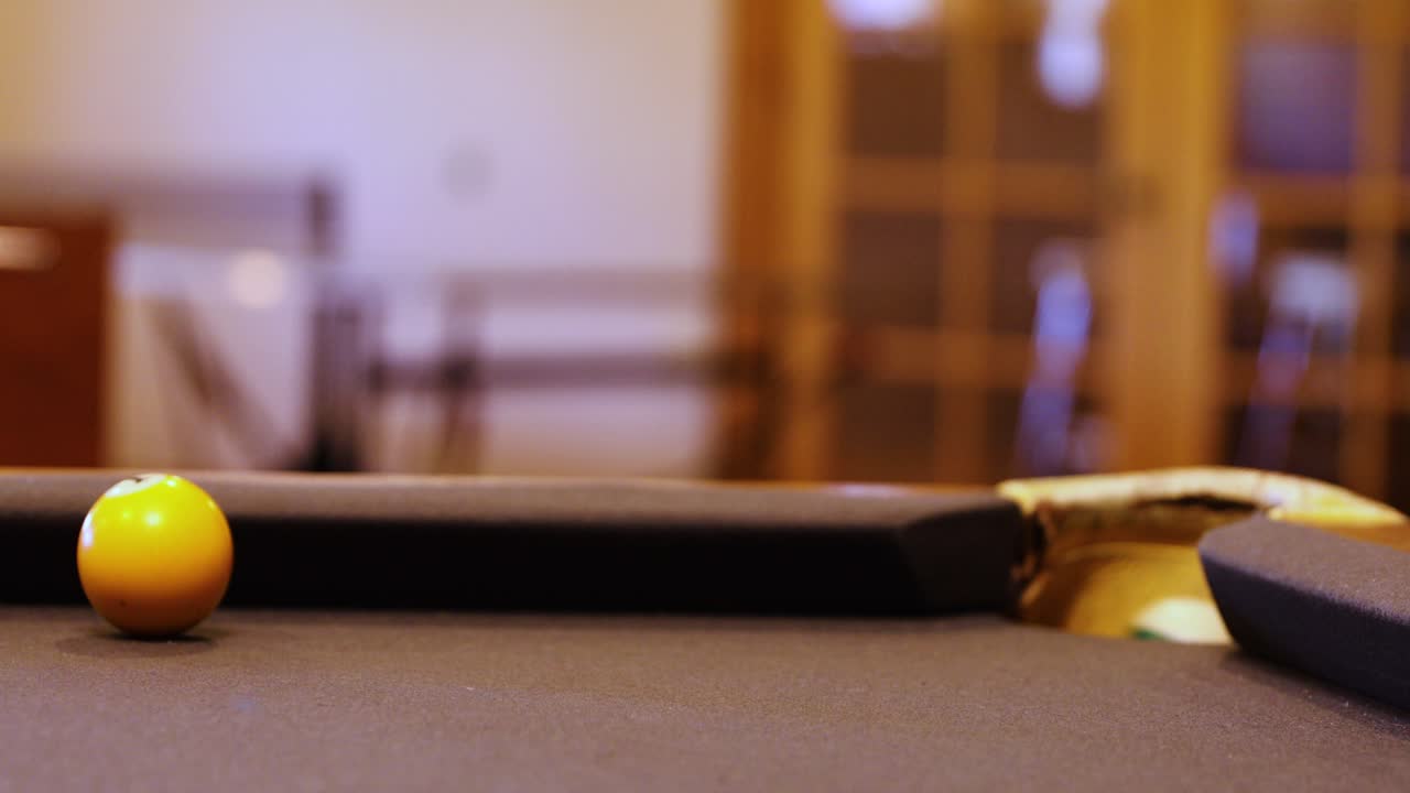 Close-up Of A Cue Stick Hitting A Green Ball