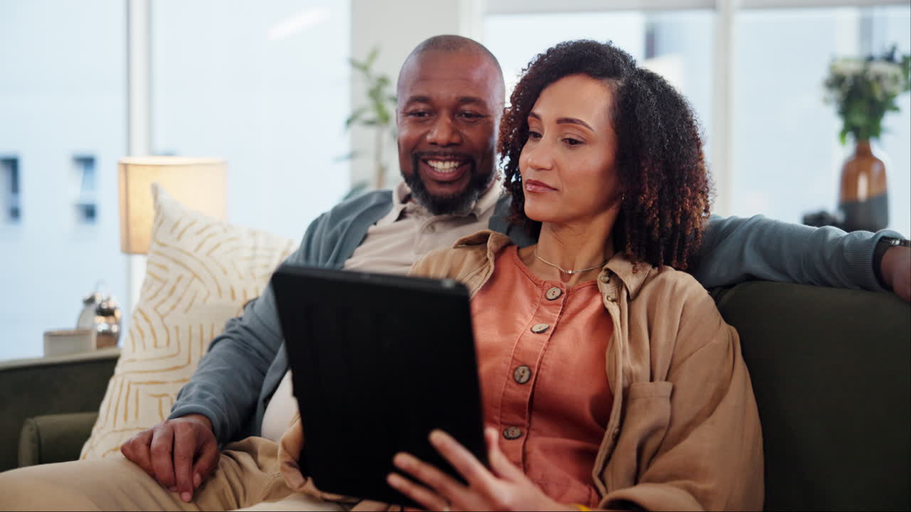 Couple using a tablet at home