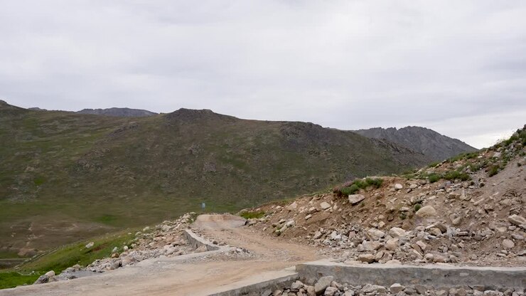Strada sterrata tortuosa attraverso colline rocciose verso il Parco Nazionale di Deosai ad Astore. Gilgit-Baltistan, Pakistan