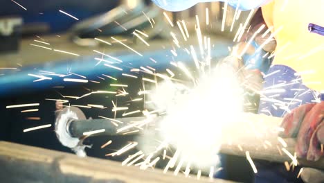 welder working on metal pipe