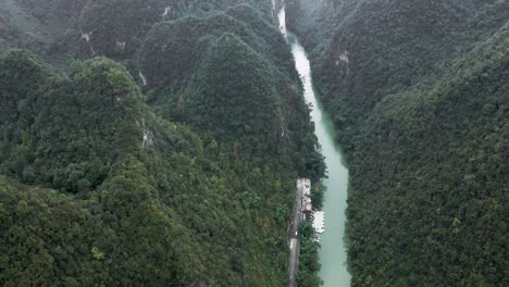 Amazing-karst-mountain-river-landscape,-misty-scenery,-aerial-tilt-reveal