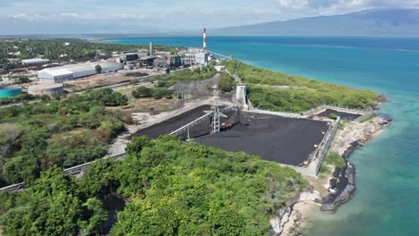 aerial view of carbon para las maquinarias del ingenio barahona, energy plant in shoreline of punta portillo in dominican republic