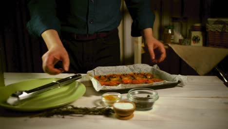 man prepared homemade dinner. man shifts freshly baked pumpkin on plate