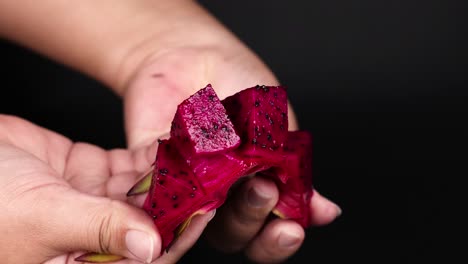 hands peeling and displaying vibrant dragon fruit