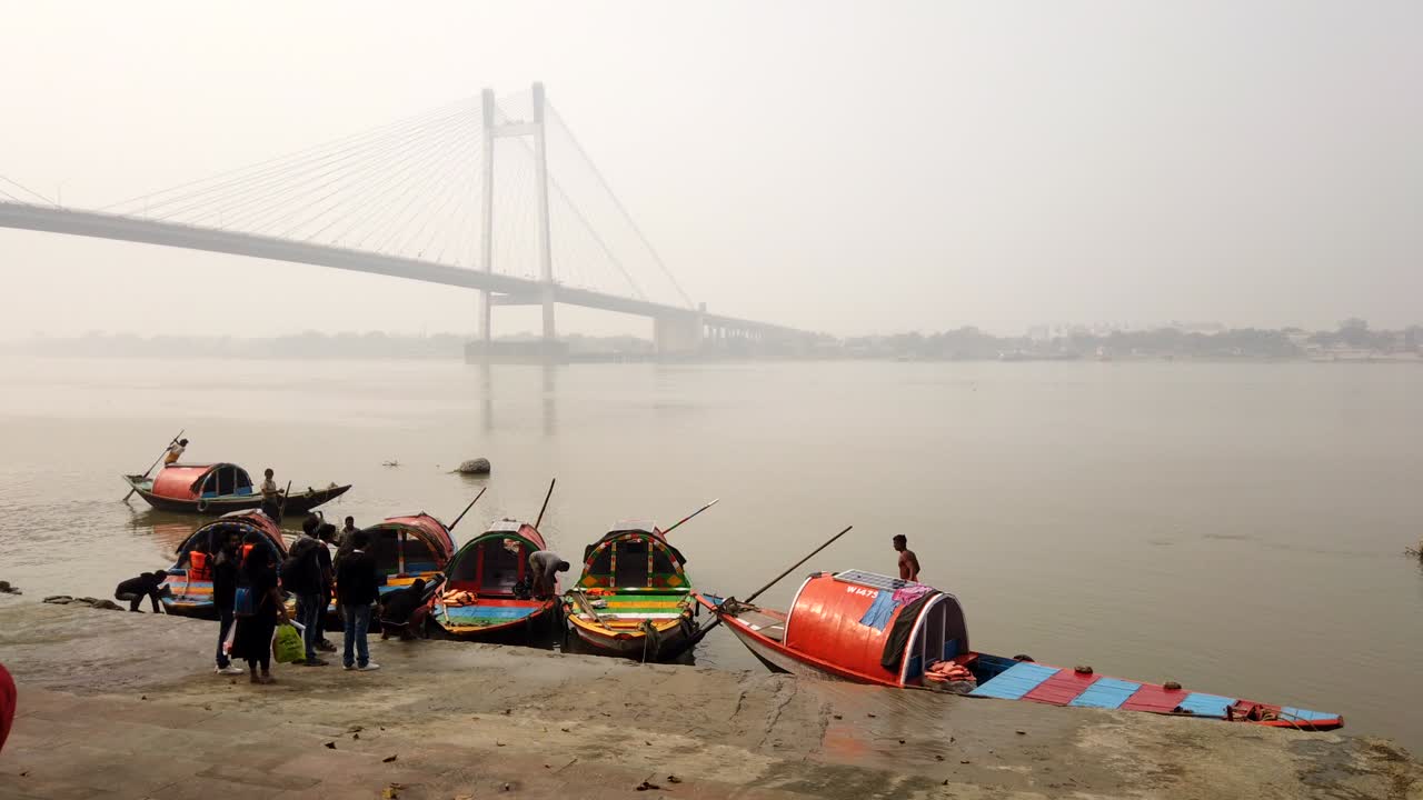 Kolkata: Timelapse of the colorful boats in the Babughat along with the iconic Hoogly bridge (Vidyasagar setu) in the background