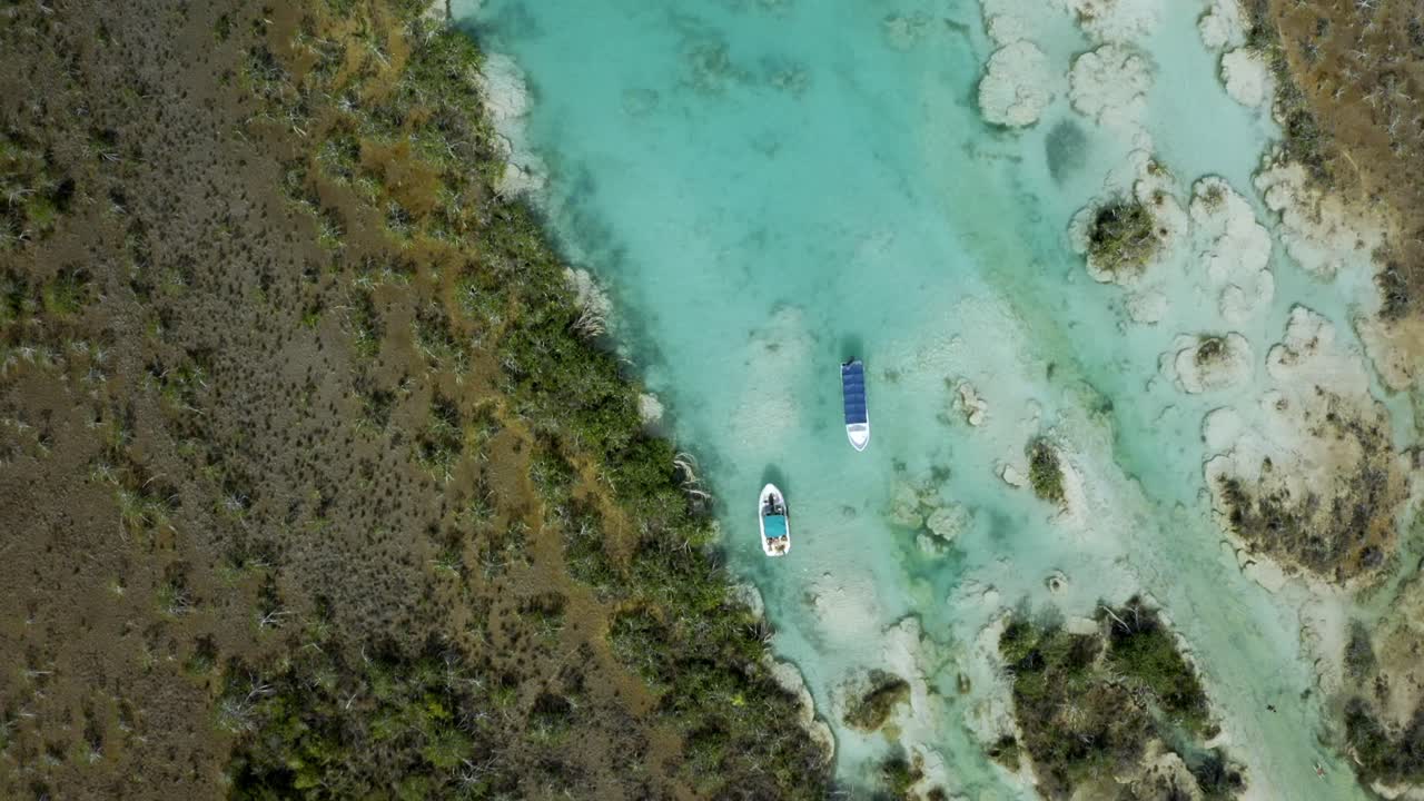 An stunning aerial drone shot showcases the famed Laguna de Bacalar, also known as the "Lagoon of Seven Colors," in Quintana Roo, Mexico