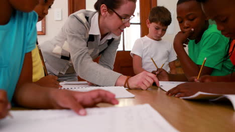 pupils all working at the same desk in classroom